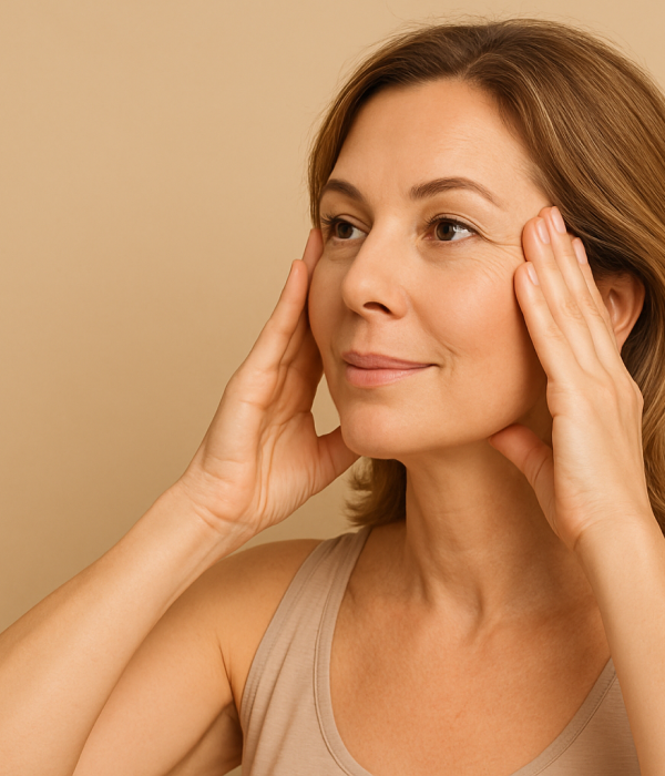 Woman demonstrating face fitness temple massage exercise